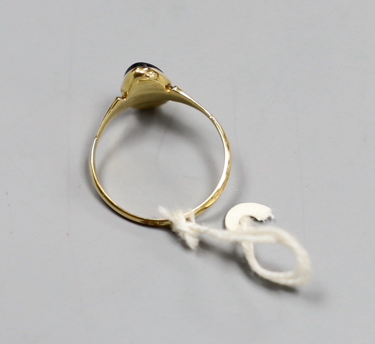 An 18ct gold and black cameo dress ring, carved with a dancing lady, size T, gross 2.8 grams